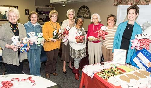 Women holding teddy bears